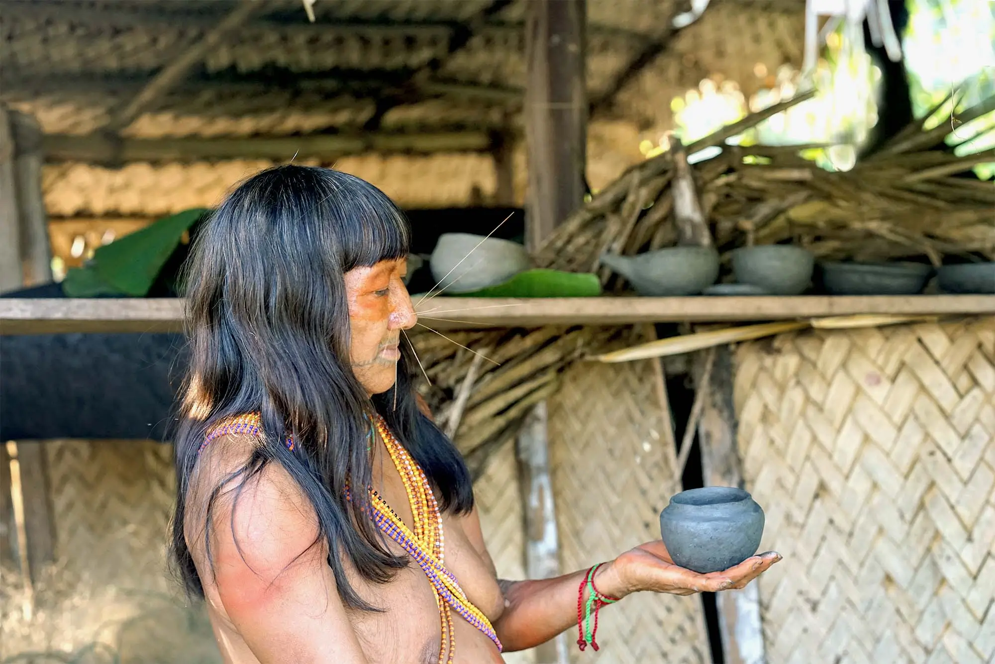 Indigenous Matsés Woman Crafting and Holding Traditional Clay Pottery